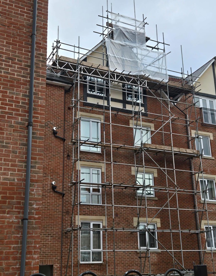 Access scaffold for gable and dormer roof repairs at Stone Court in Crawley