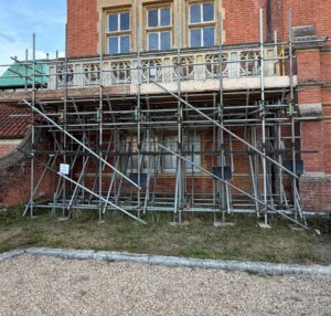 Scaffold support and working platform along the listed balcony at Minley Manor in Camberley
