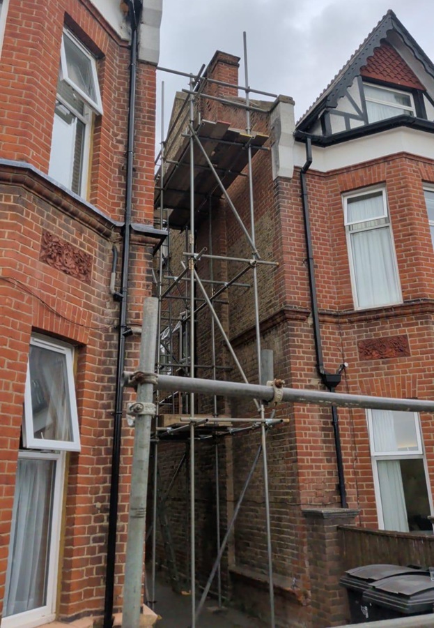 Scaffold providing access to the gable-end parapet wall at a property in Surbiton KT5