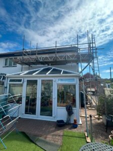 Scaffold spanning a conservatory at a property on Newbroke Road, Gosport