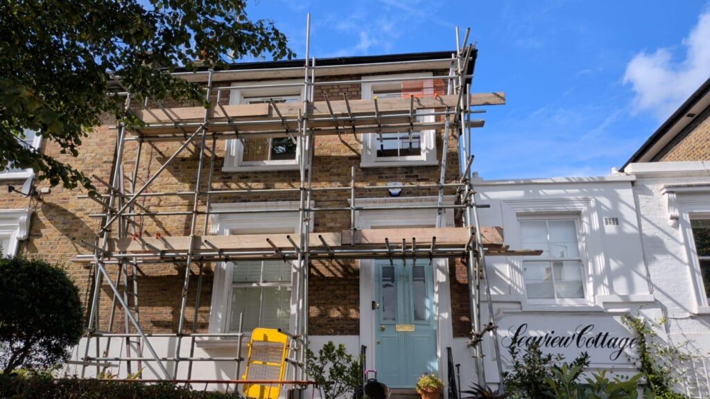 Scaffolding with ladder access installed outside a two-storey property on Southgate Road, London