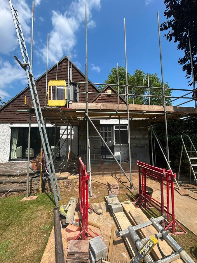 Two-lift scaffold providing access around a two-storey extension in Weybridge