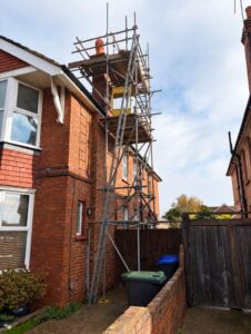 Chimney scaffold platform with toe boards and guardrails above Chatham Road, Worthing