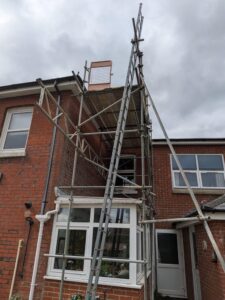 Lattice beam fixed to the scaffold and spanning over a conservatory to the first-floor window ledge in Southampton