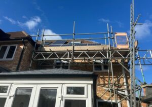 Access scaffold over conservatory for solar panels in Guildford